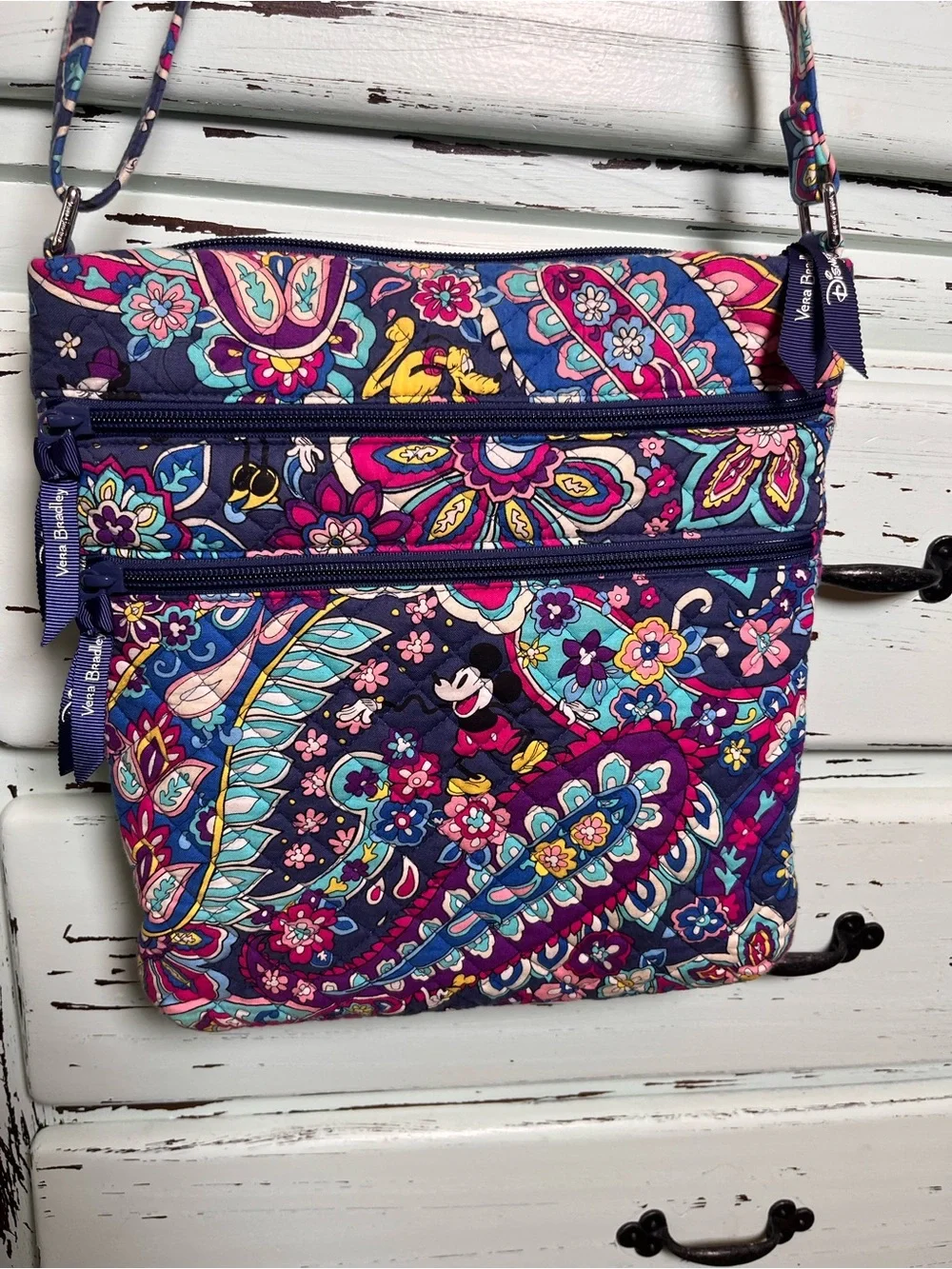Vera Bradley Disney Collab Triple Zip Hipster in sensational six pattern.